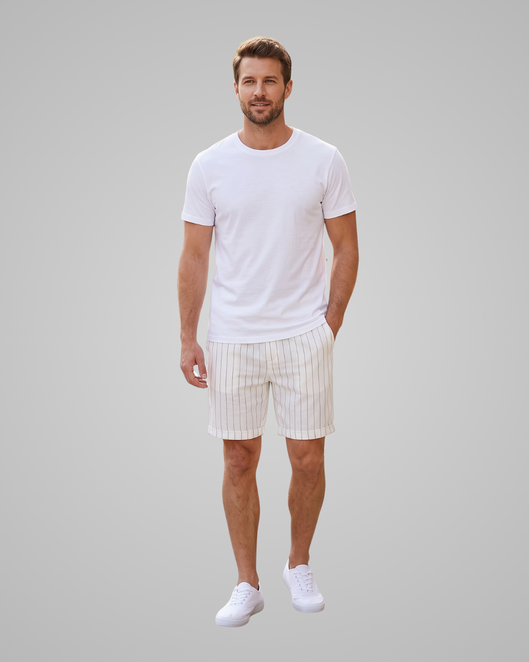 A man modeling a white short-sleeve crewneck t-shirt and off-white pinstriped shorts against a solid gray studio background.
