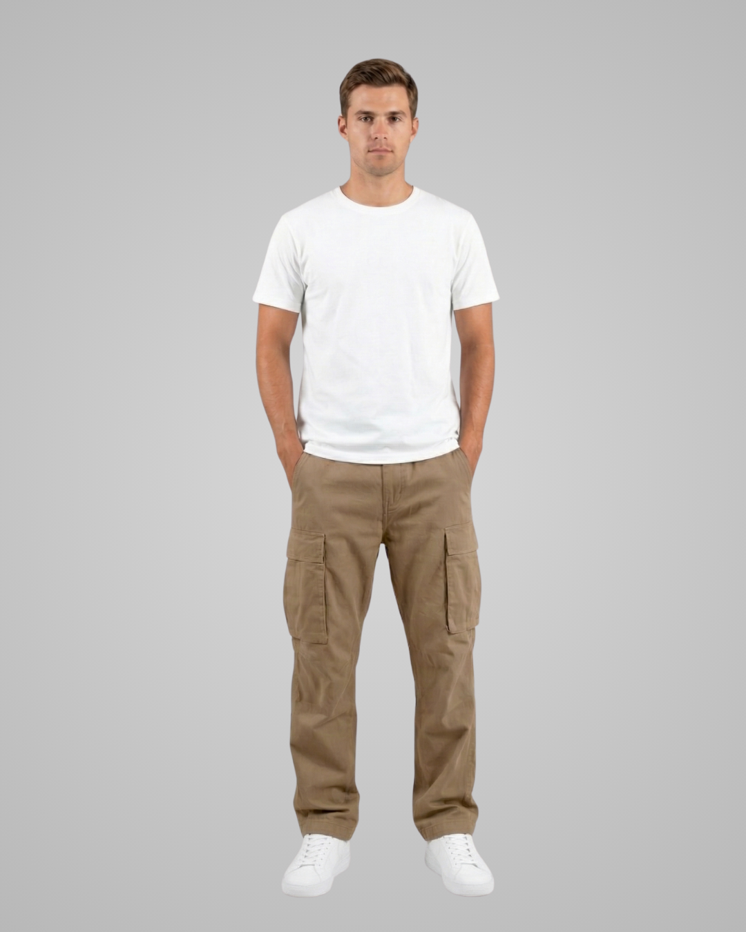 Man wearing a white t-shirt and brown cargo pants on a gray background