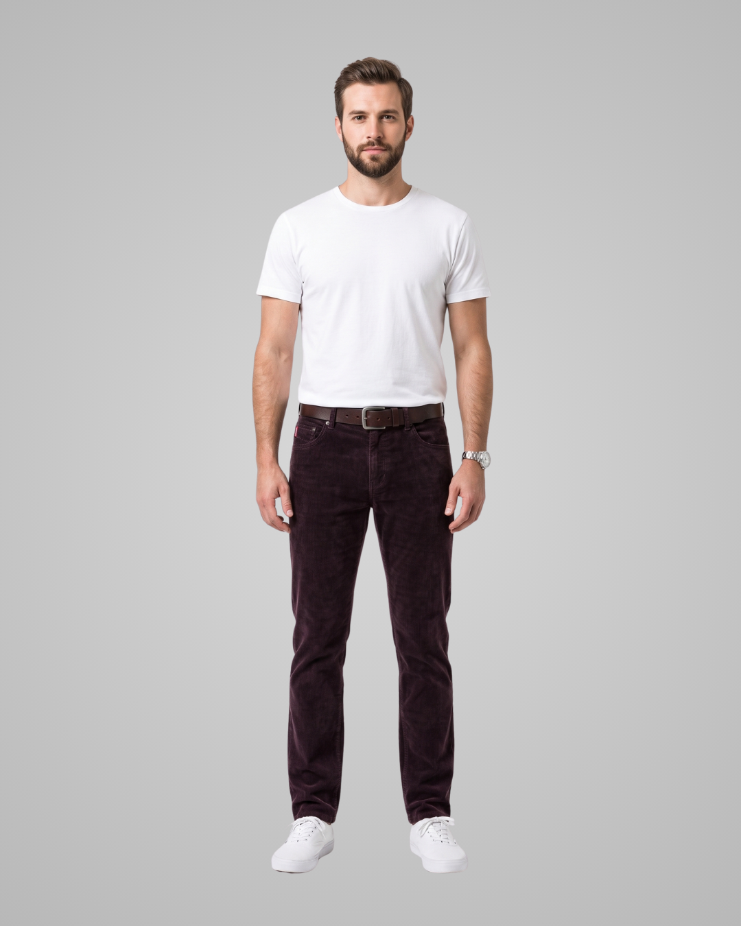 Man wearing a white t-shirt and dark pants on a gray background