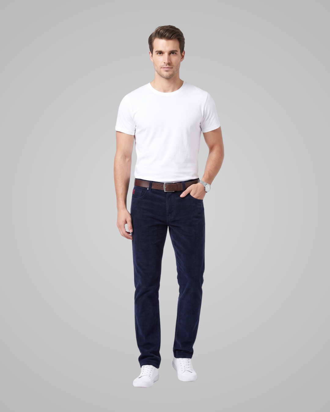 Man wearing a white t-shirt and navy pants on a gray background