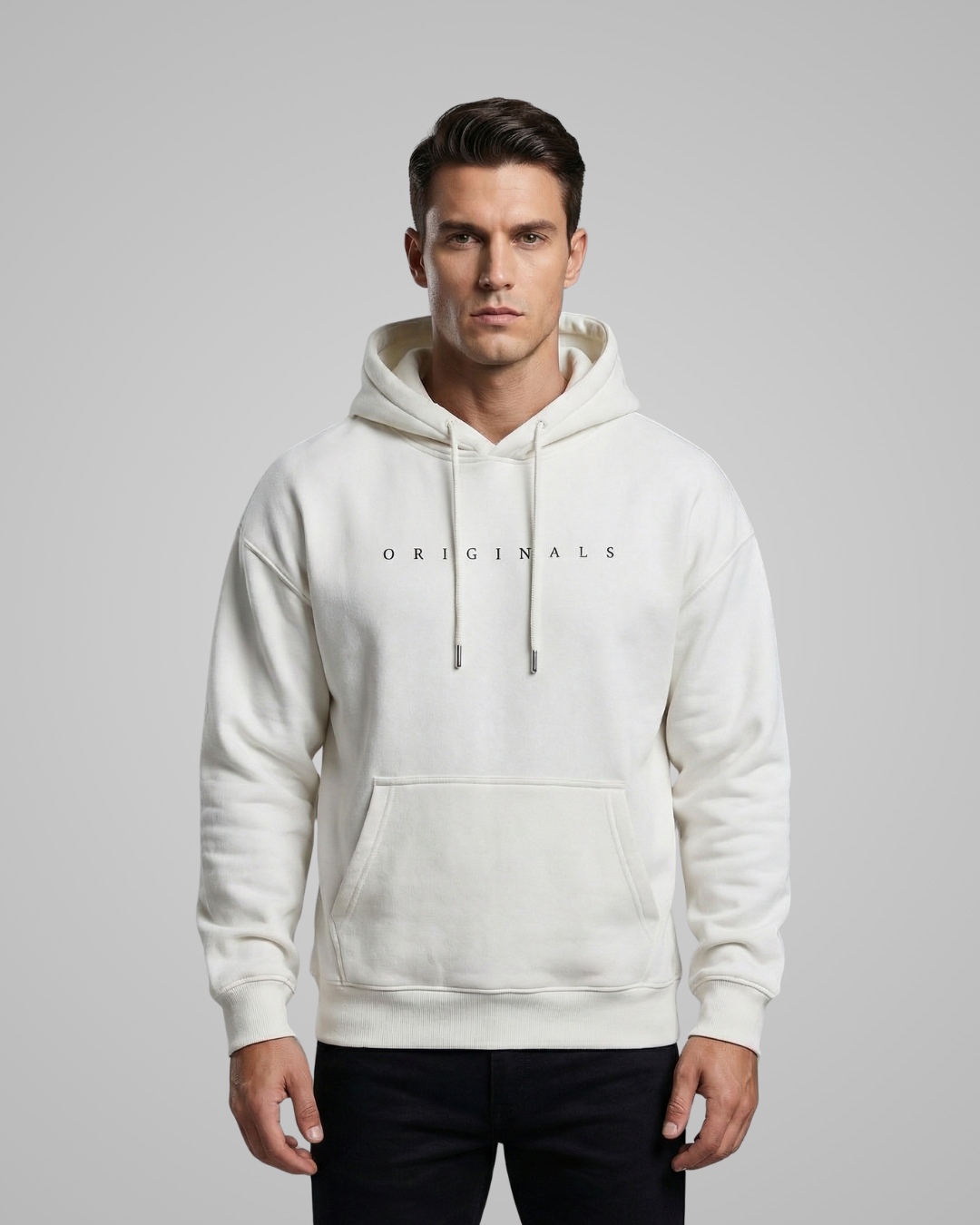 Man wearing a white hoodie with 'ORIGINALS' text on a gray background