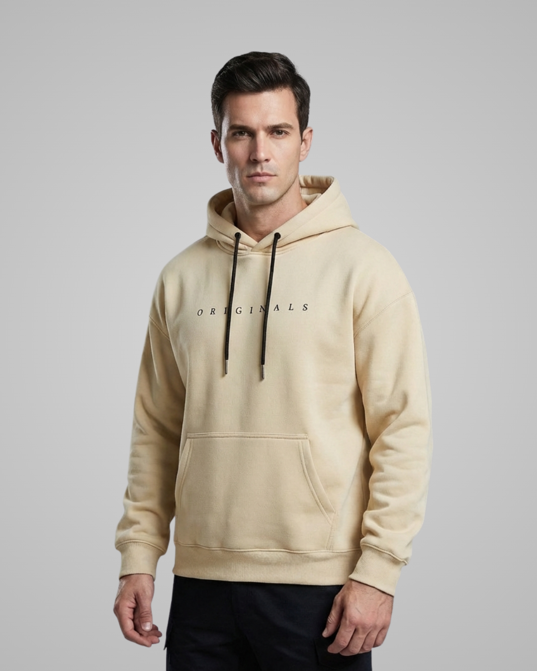Man wearing a beige hoodie with 'Originals' text on a gray background