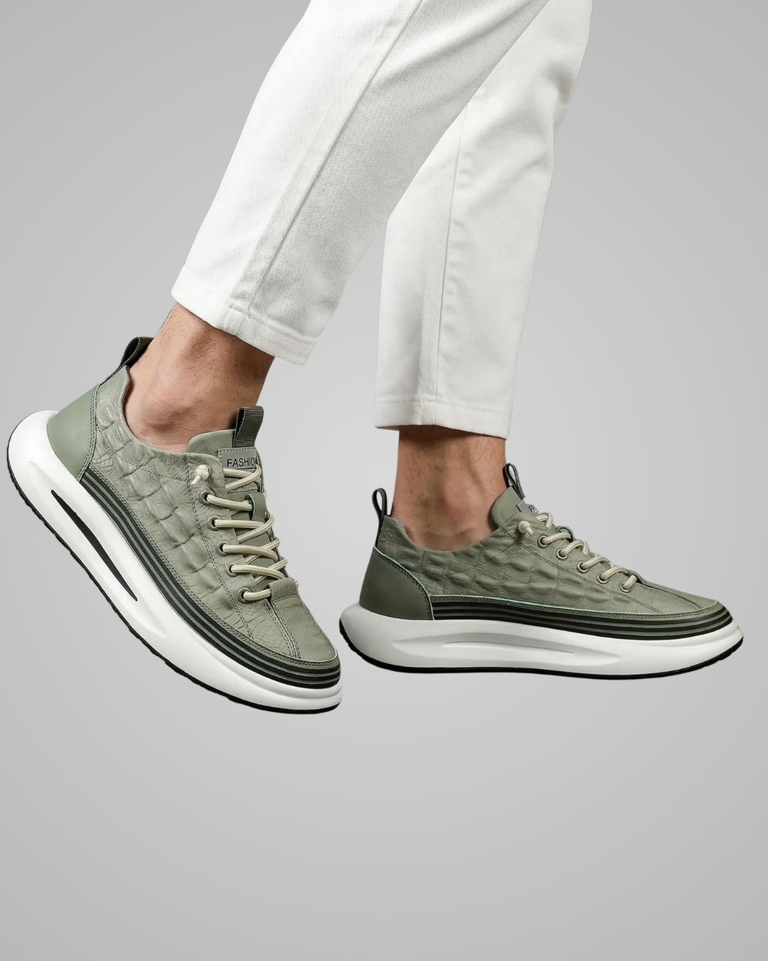 Person wearing green sneakers with white soles on a gray background
