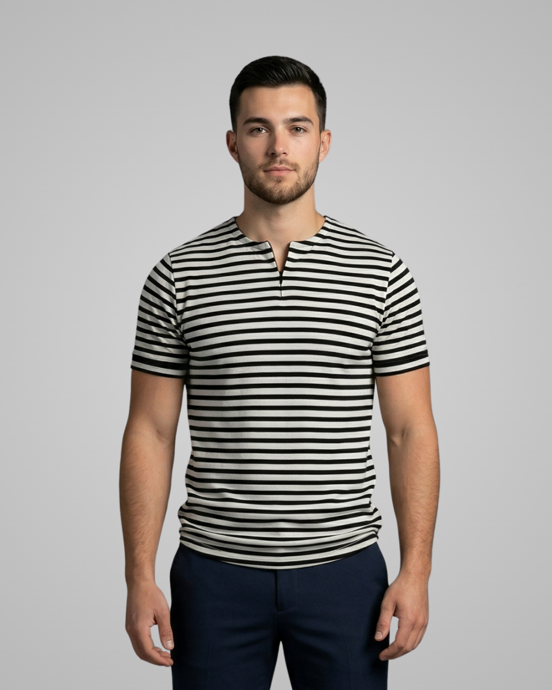Man wearing a black and white striped shirt against a gray background