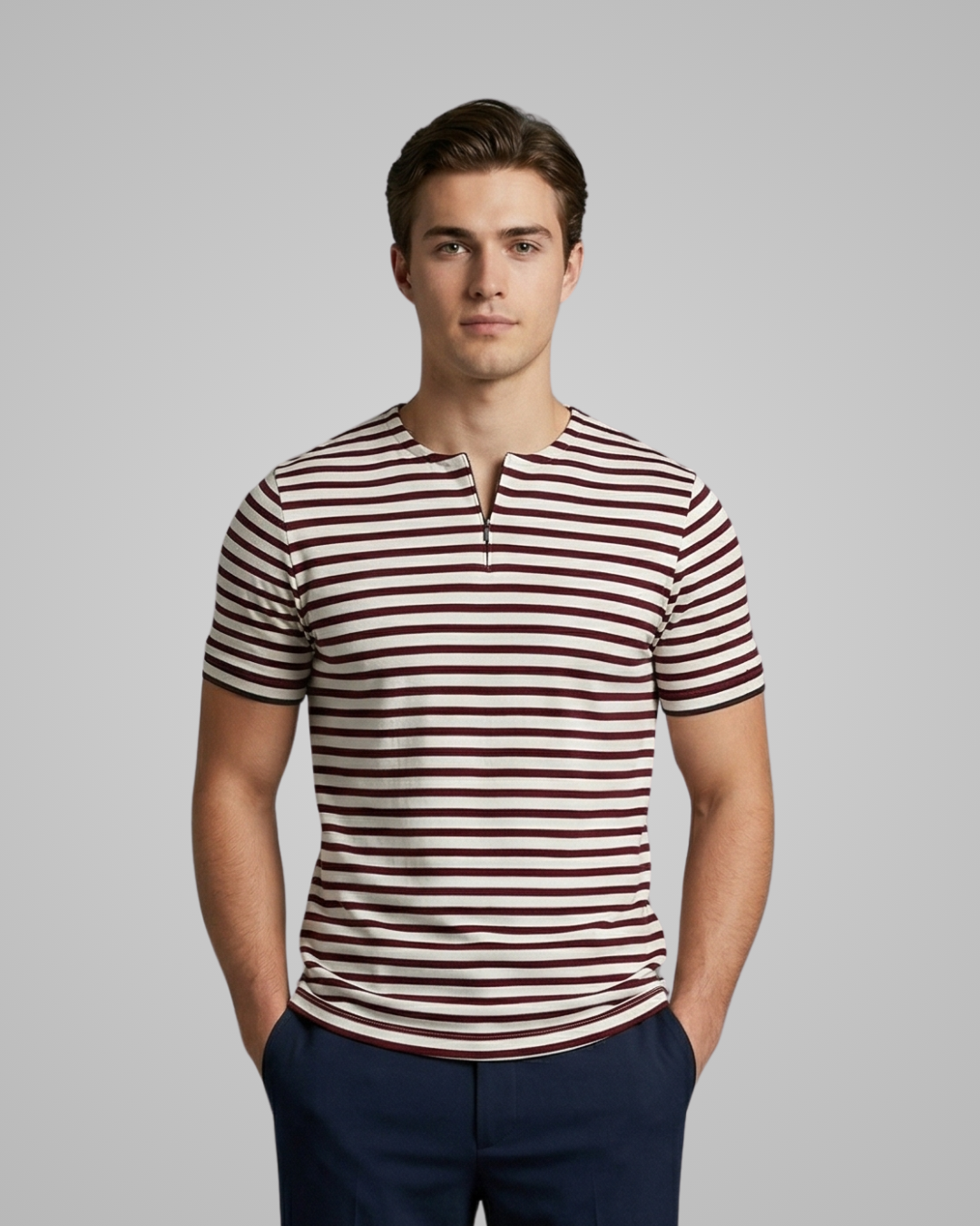 Man wearing a striped shirt with a neutral background