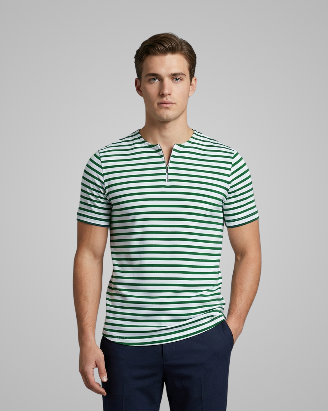 Man wearing a green and white striped shirt against a gray background