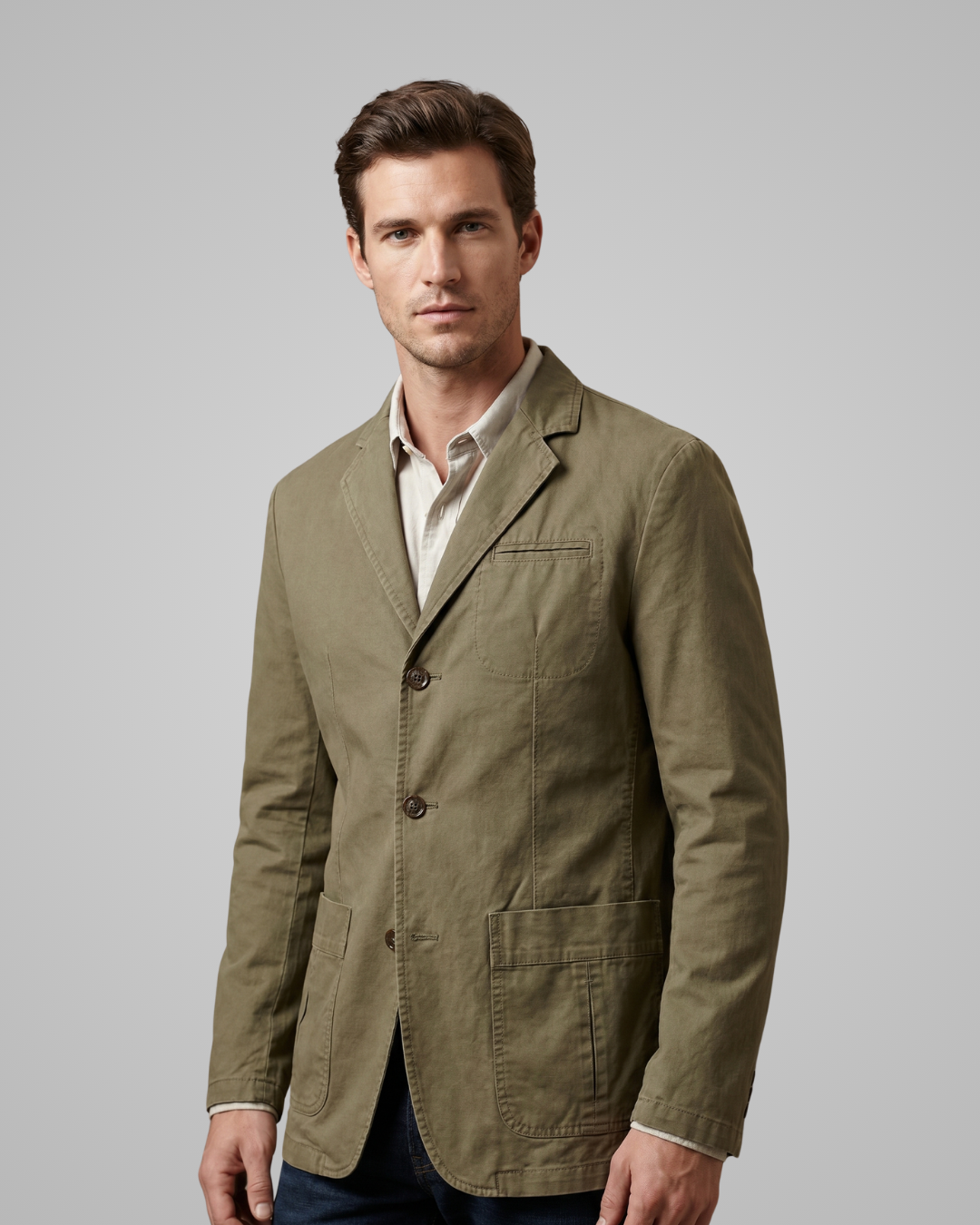 Man wearing a green jacket against a gray background