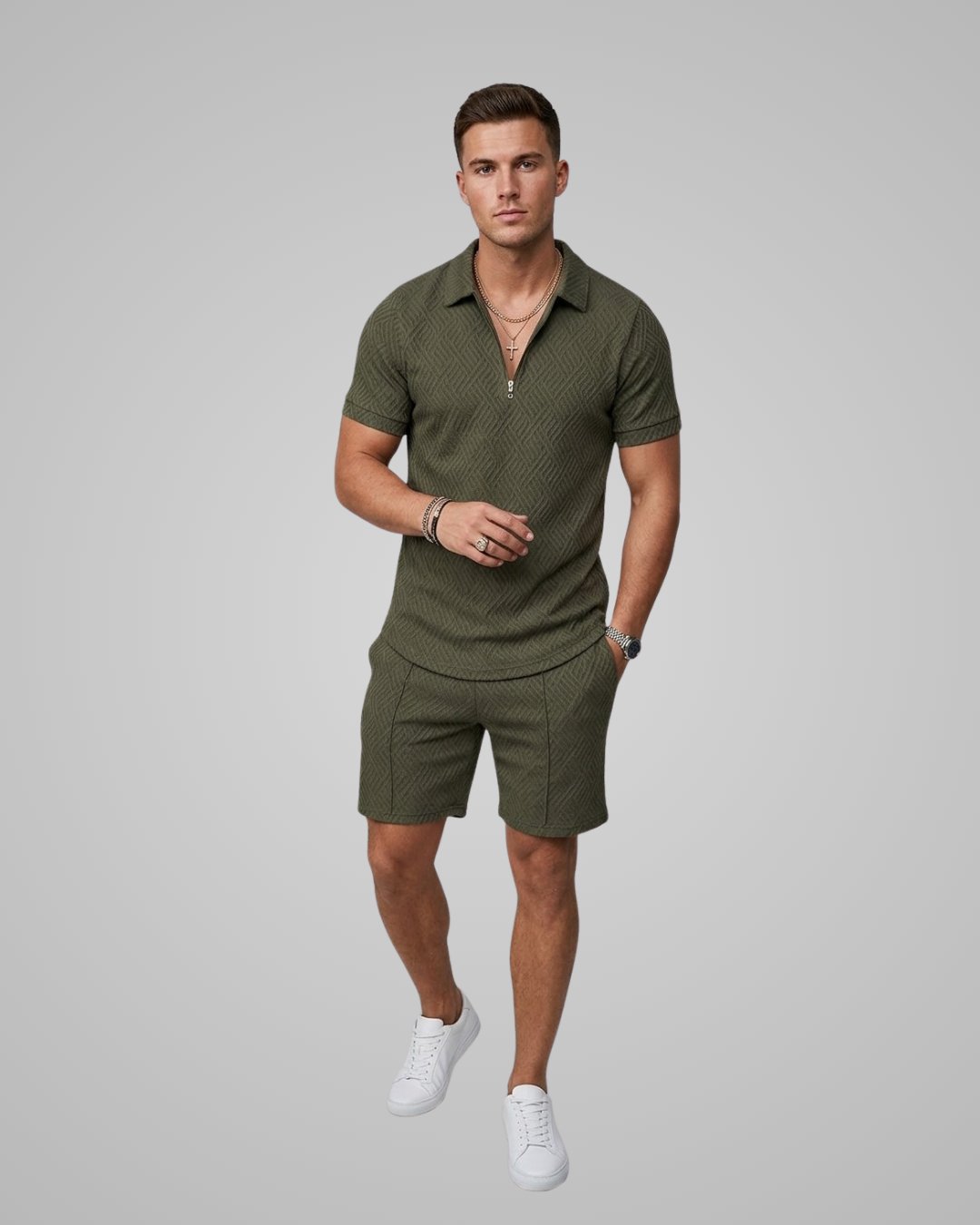 Man wearing a green polo shirt and shorts set on a gray background