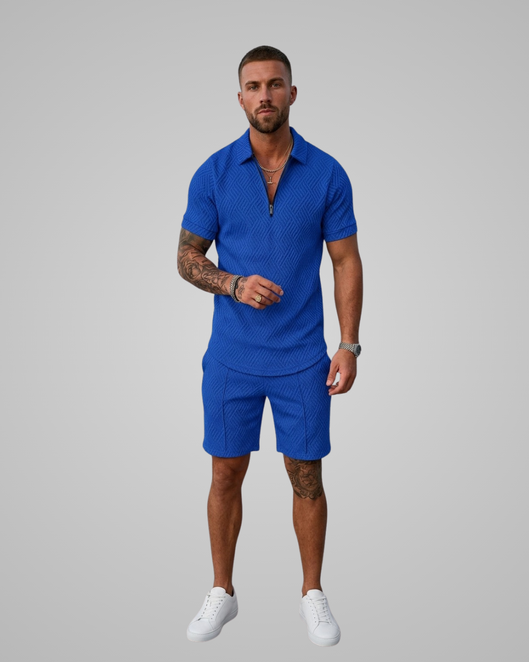 Man wearing a blue outfit with a matching polo shirt and shorts on a gray background