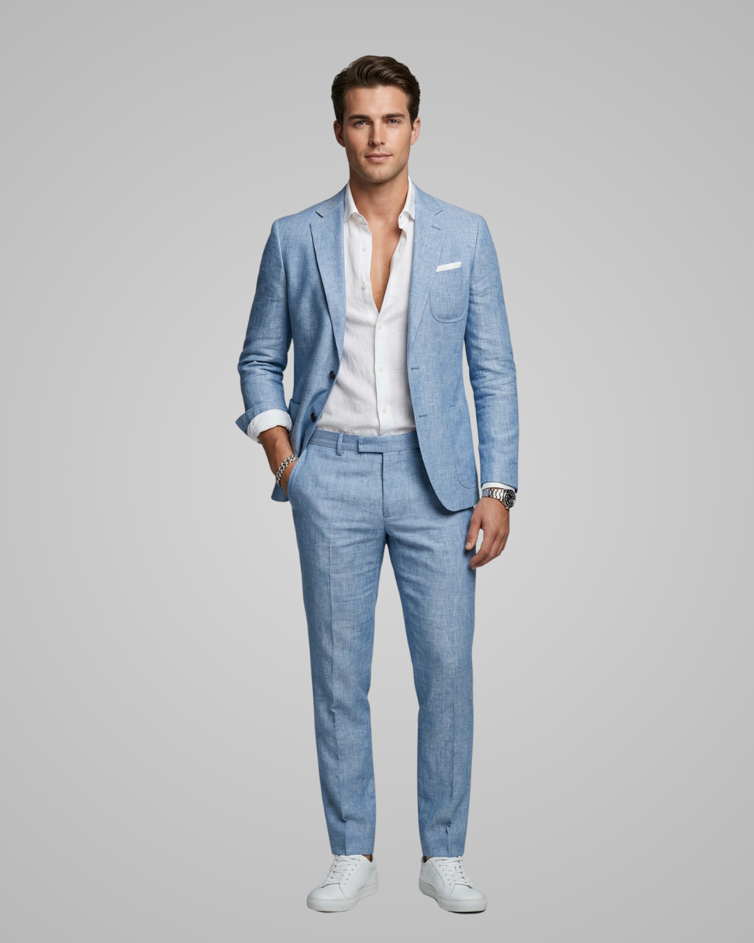 Man wearing a light blue suit with a white shirt on a gray background