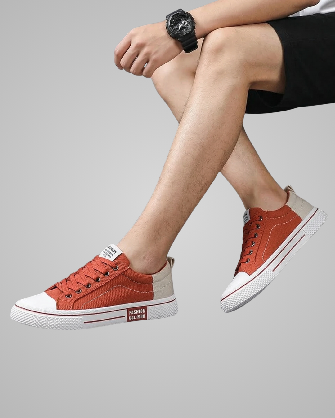 Person wearing red sneakers with white soles on a gray background