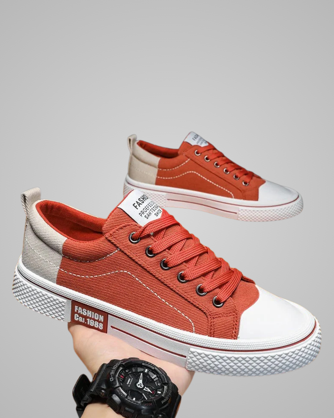 Red and white sneakers with a visible brand label on a gray background