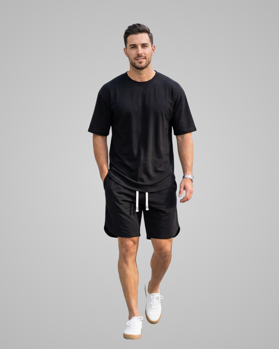 Man wearing a black t-shirt and shorts on a gray background