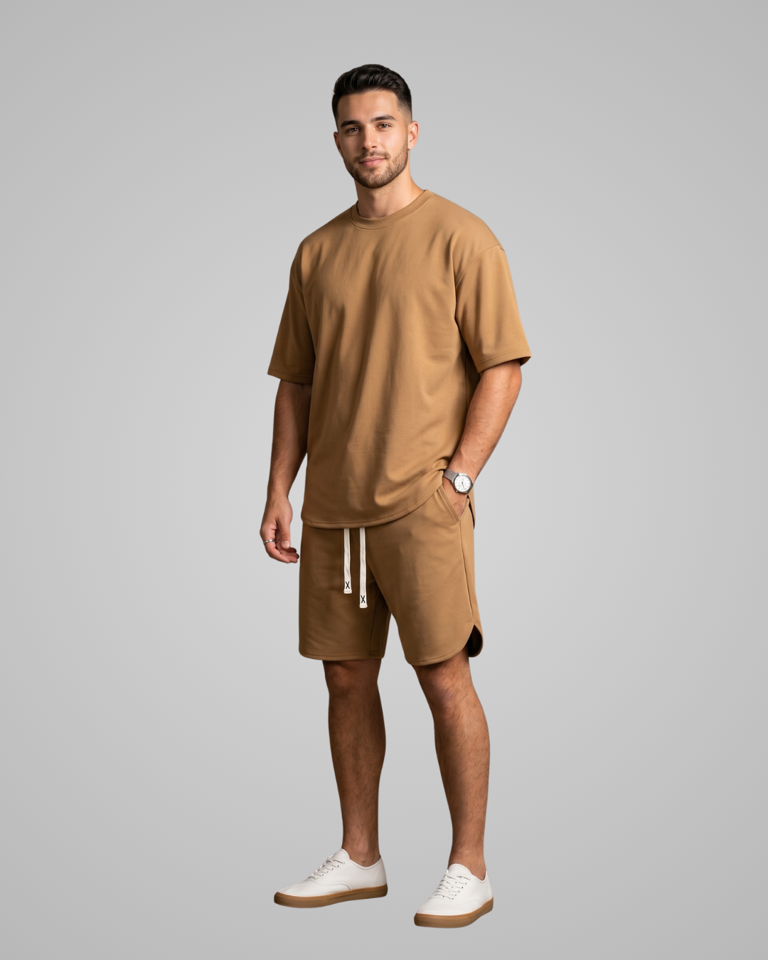 Man wearing a brown outfit with shorts and a t-shirt on a gray background