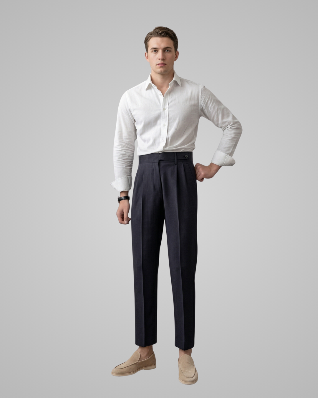 Man wearing a white shirt and dark pants on a gray background