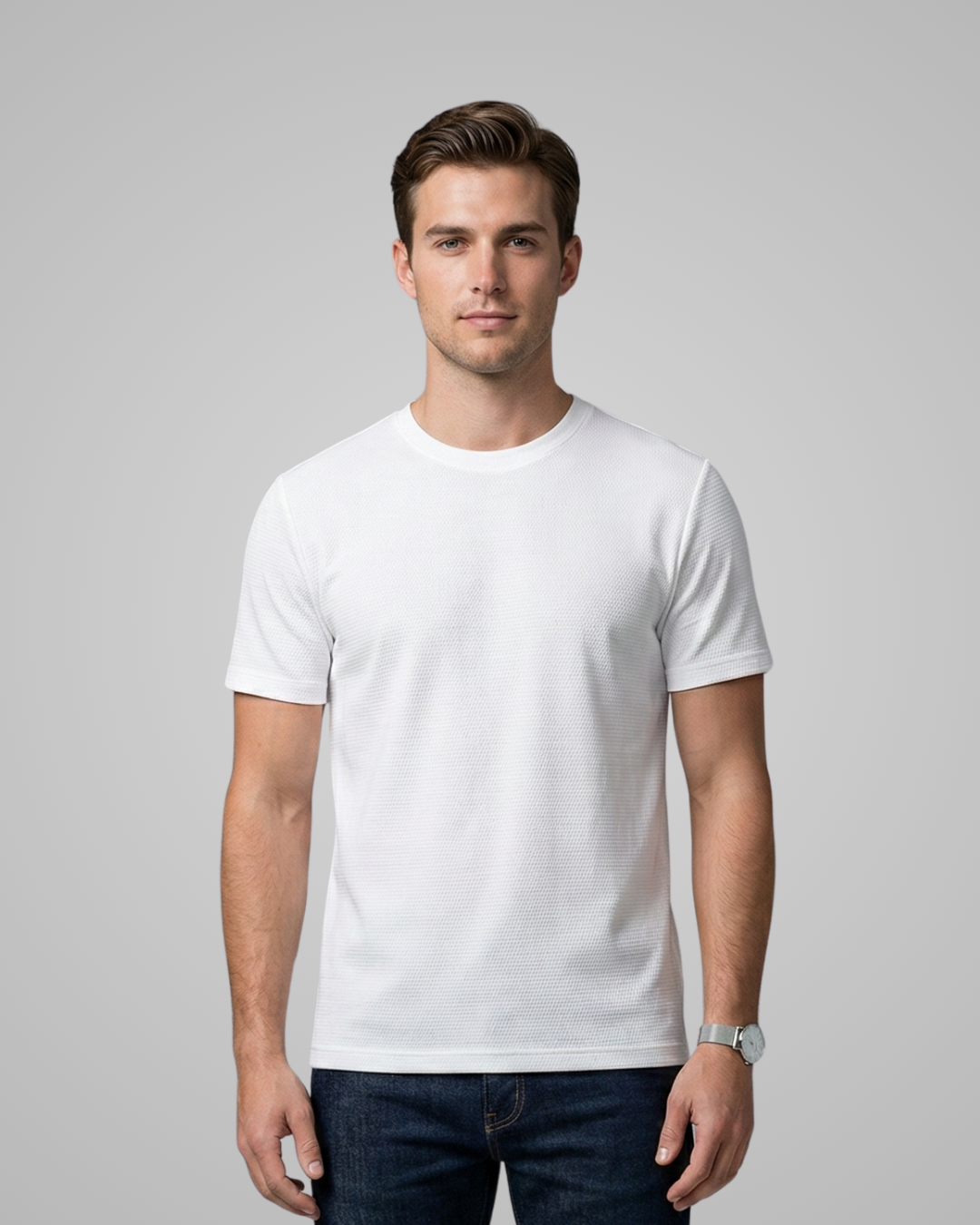 Man wearing a white t-shirt against a gray background