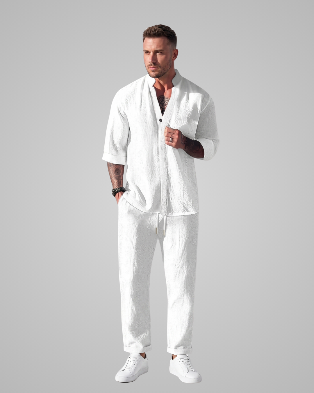 Man wearing a white outfit with a plain background