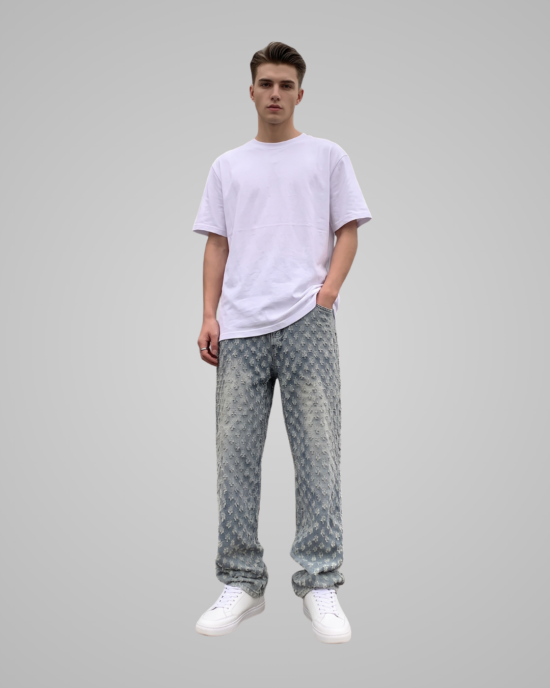 Person wearing a plain white t-shirt and patterned pants on a gray background