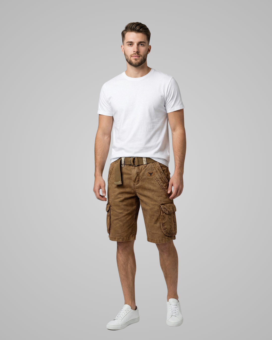 Man wearing a white t-shirt and brown cargo shorts on a gray background