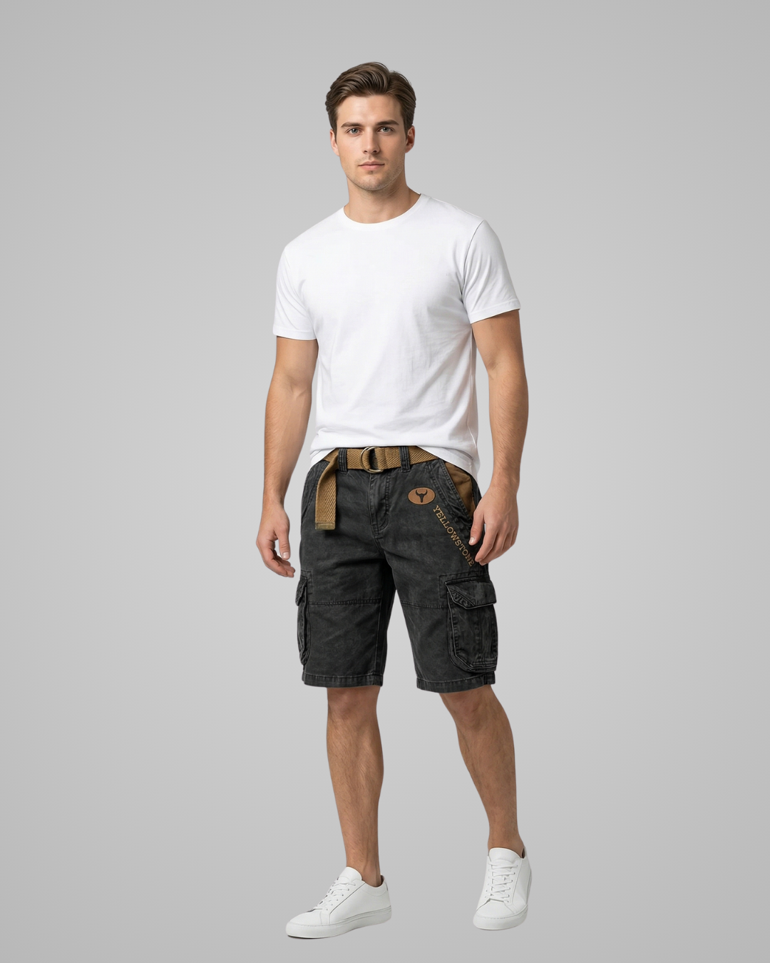 Man wearing a white t-shirt and dark cargo shorts on a gray background