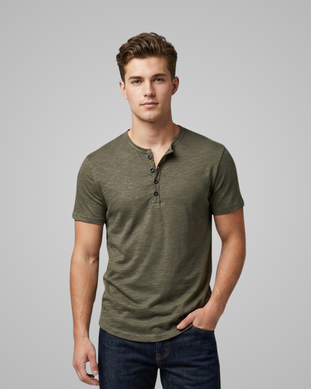 Man wearing a green henley shirt against a gray background