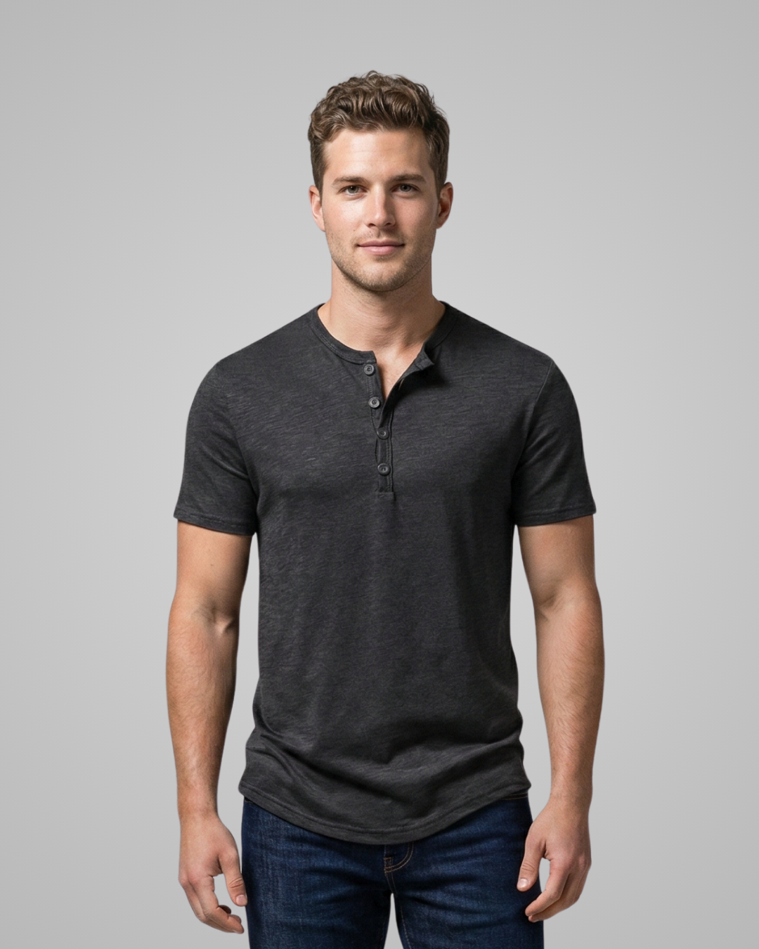 Man wearing a dark gray henley shirt against a plain background
