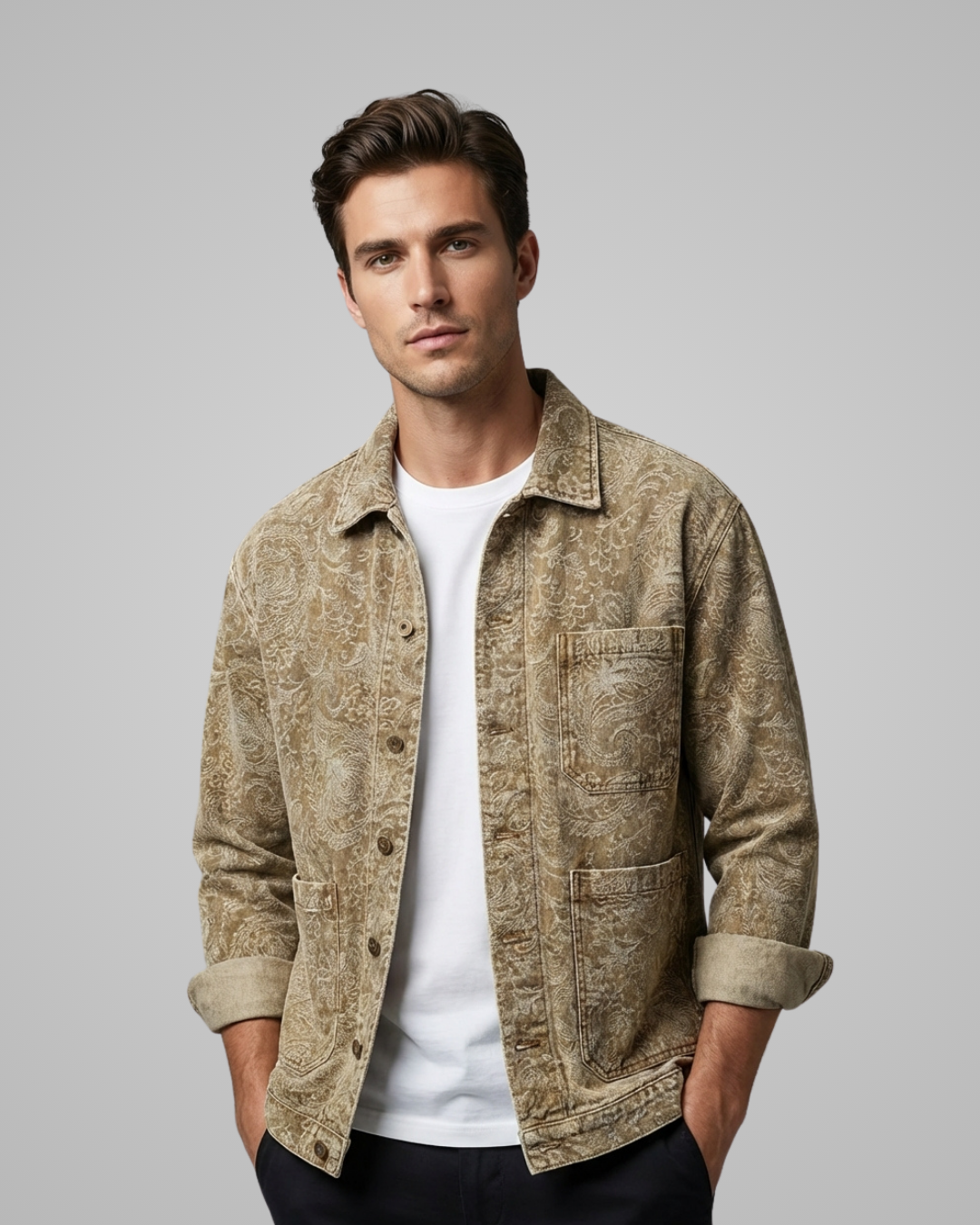 Man wearing a beige patterned jacket over a white shirt on a gray background