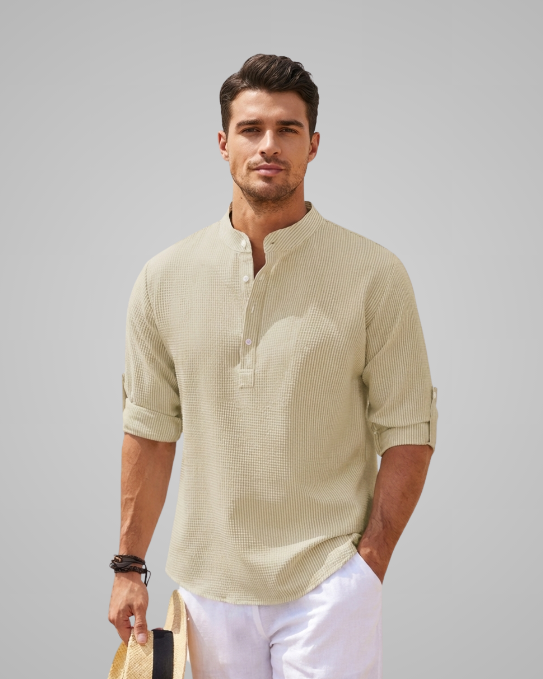 Man wearing a beige short-sleeve shirt with a plain background