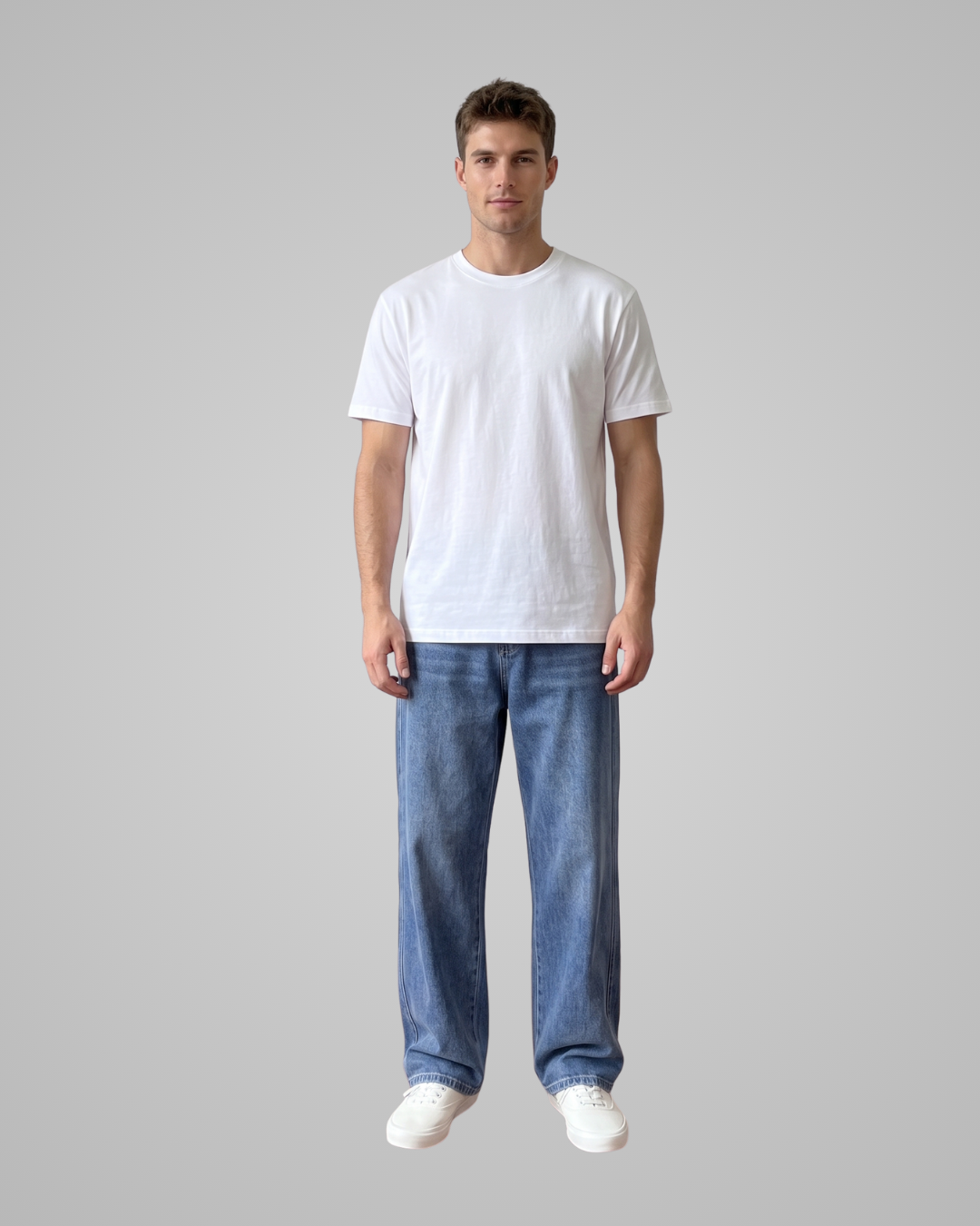 Person wearing a plain white t-shirt and blue jeans on a gray background
