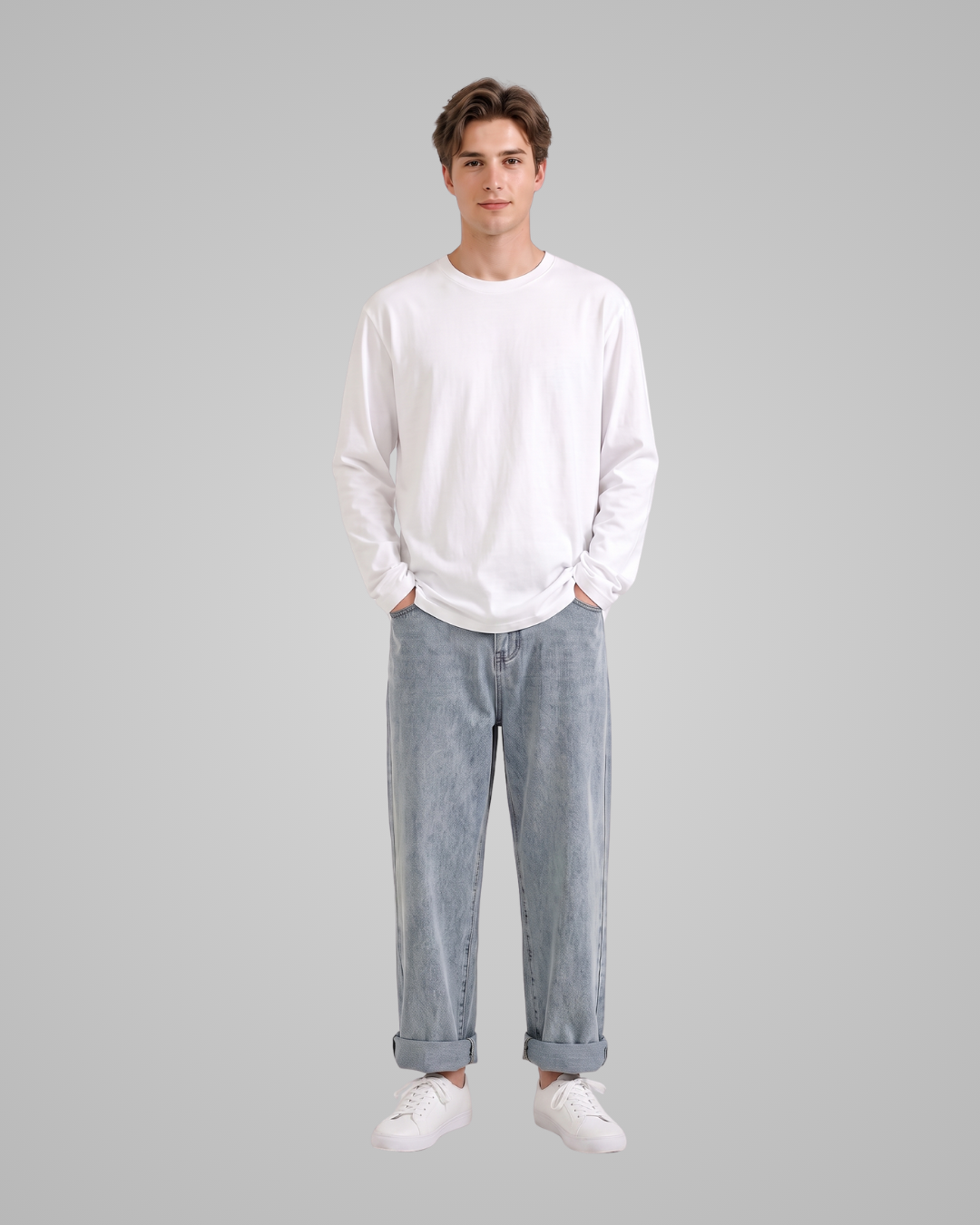 Person wearing a white sweatshirt and light blue jeans on a gray background