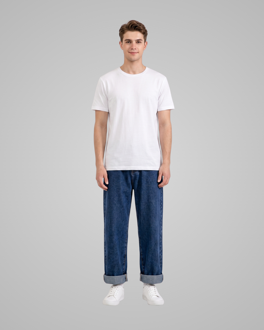 Person wearing a white t-shirt and blue jeans on a gray background