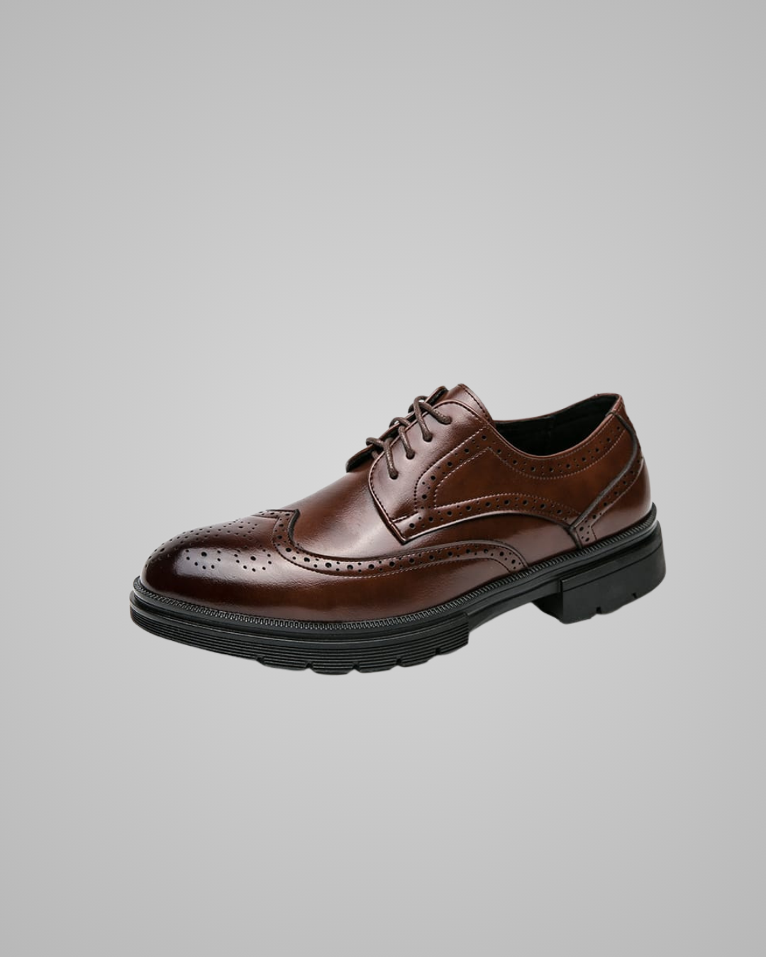 Brown leather dress shoe on a gray background