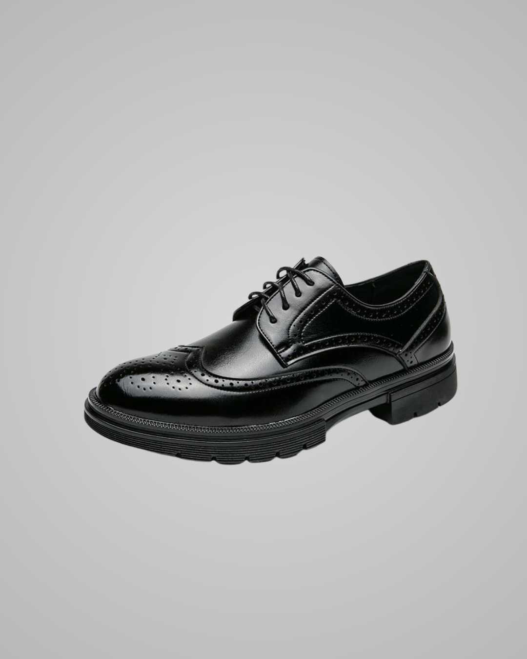 Black leather dress shoe on a gray background