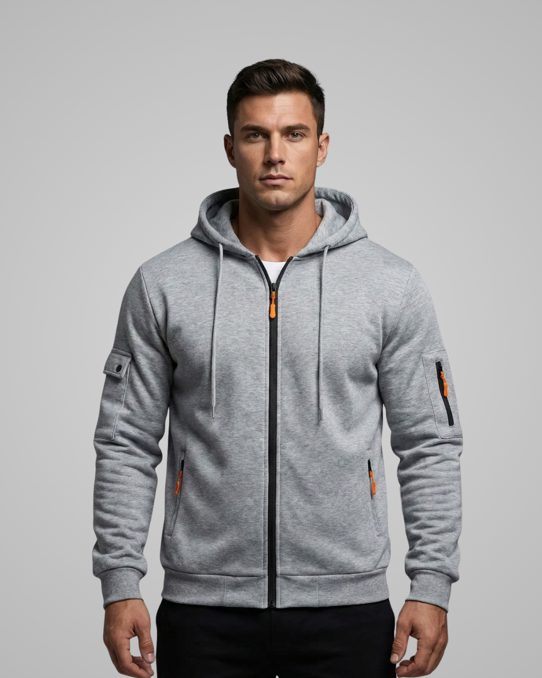 Man wearing a gray hoodie with orange accents on a gray background