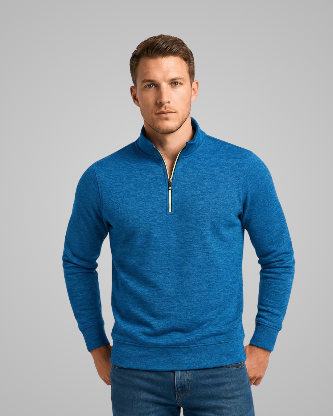 Man wearing a blue pullover with a zipper on a gray background