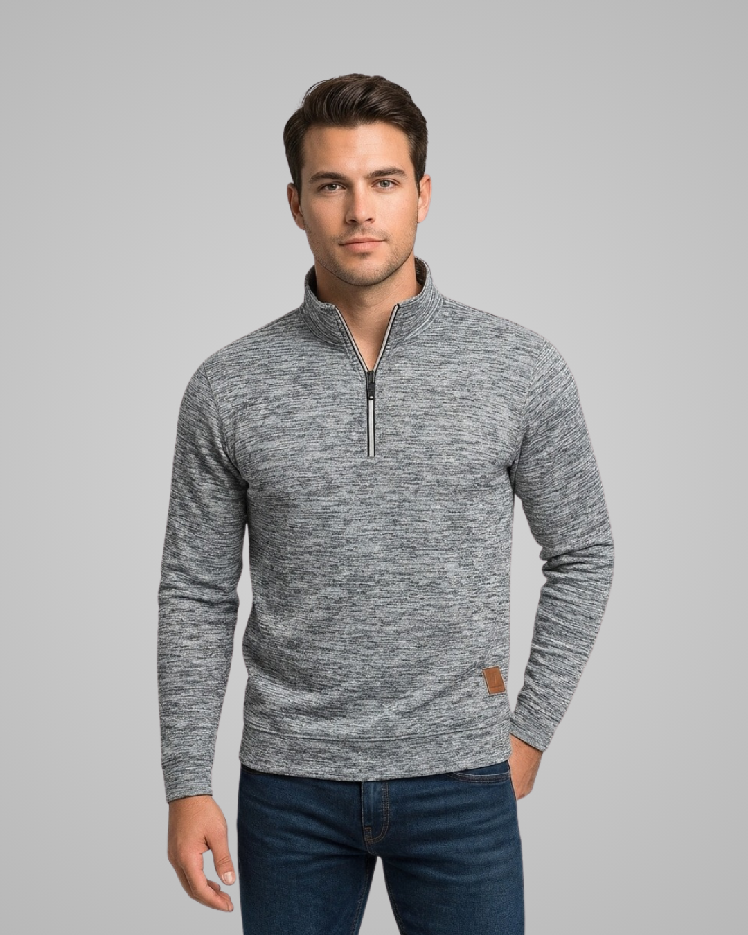 Man wearing a gray zip-up sweater against a gray background