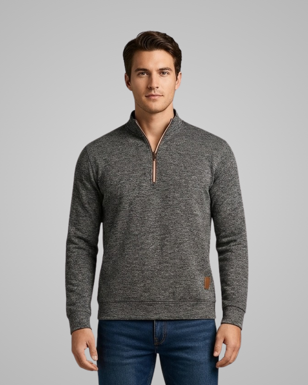 Man wearing a gray half-zip sweater with a brand logo on a gray background