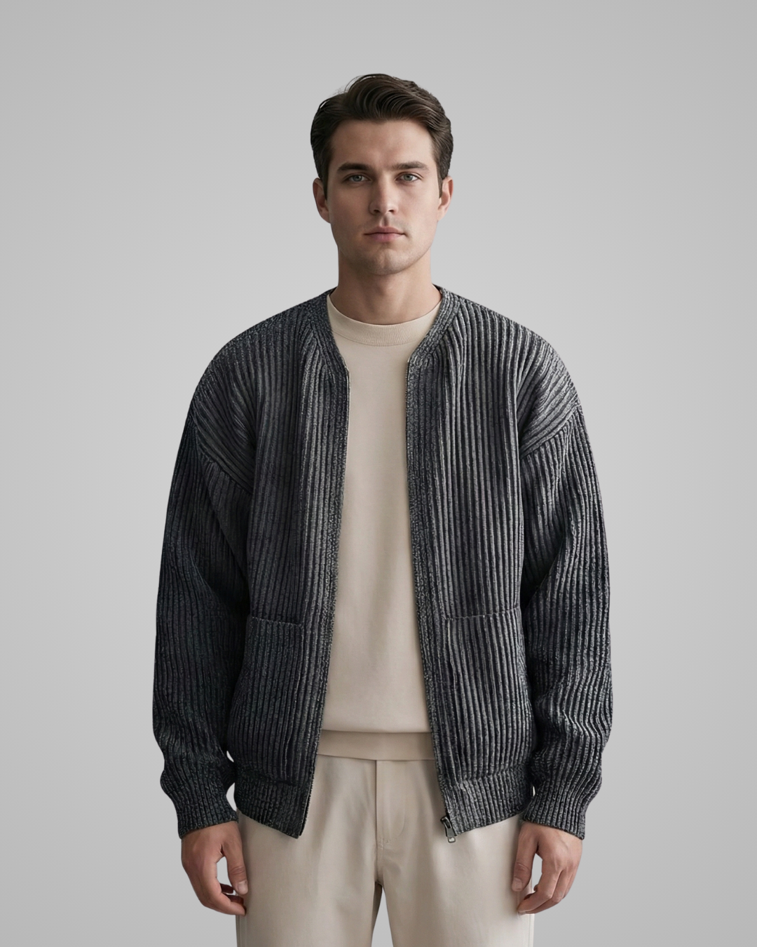 Man wearing a dark gray striped jacket over a beige shirt and pants on a light gray background