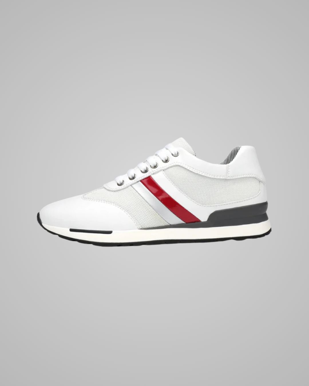 White sneaker with a red stripe on a gray background