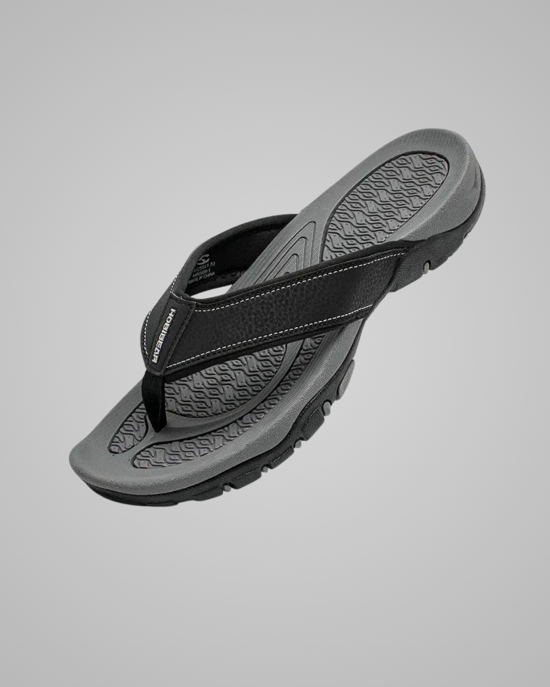 Black and gray sandal on a light gray background