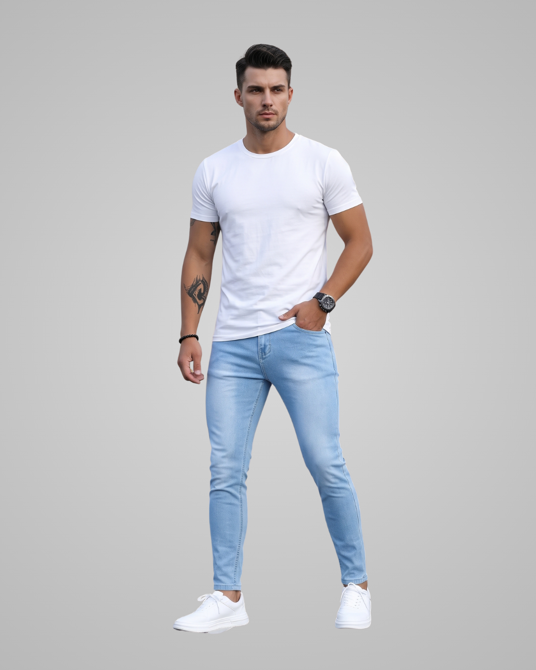 Man wearing a white t-shirt and light blue jeans on a gray background