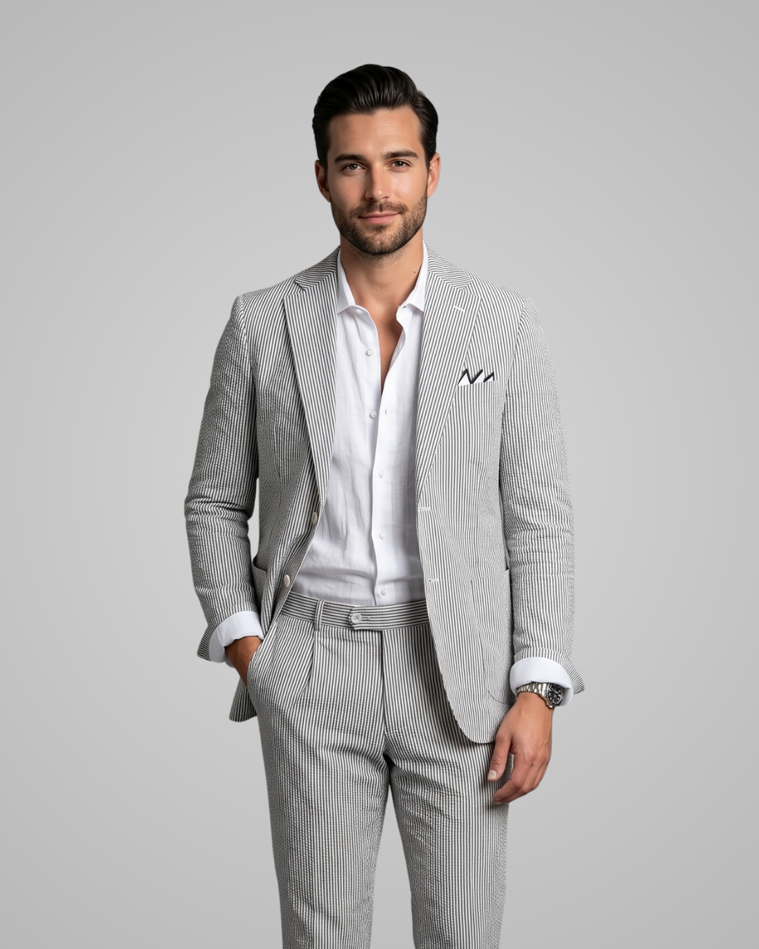 Man wearing a gray checkered suit with a white shirt on a gray background