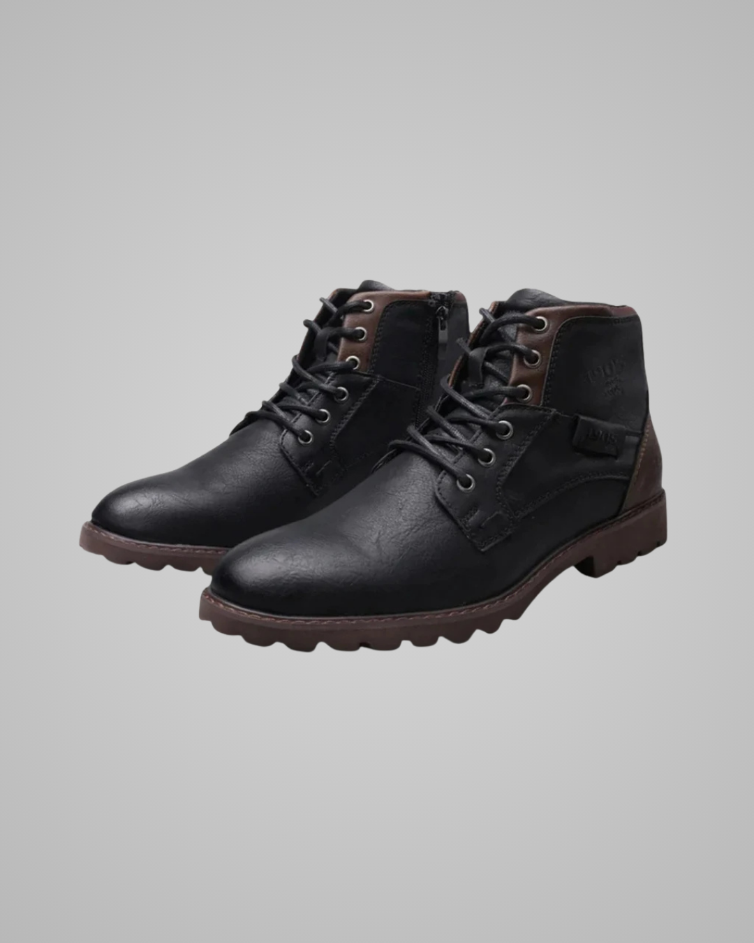 Pair of black leather boots on a gray background