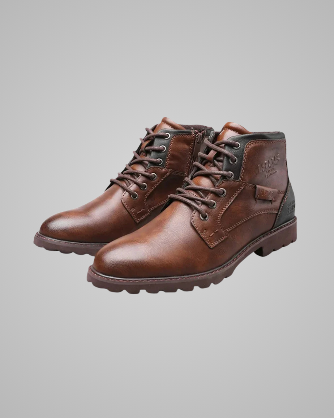Pair of brown leather boots on a gray background