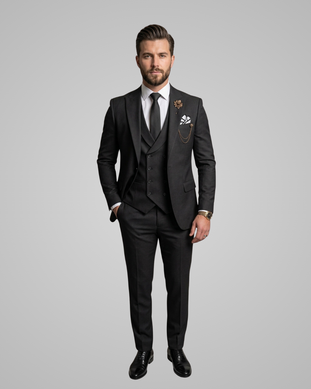 Man wearing a black suit with a white shirt and black shoes on a gray background