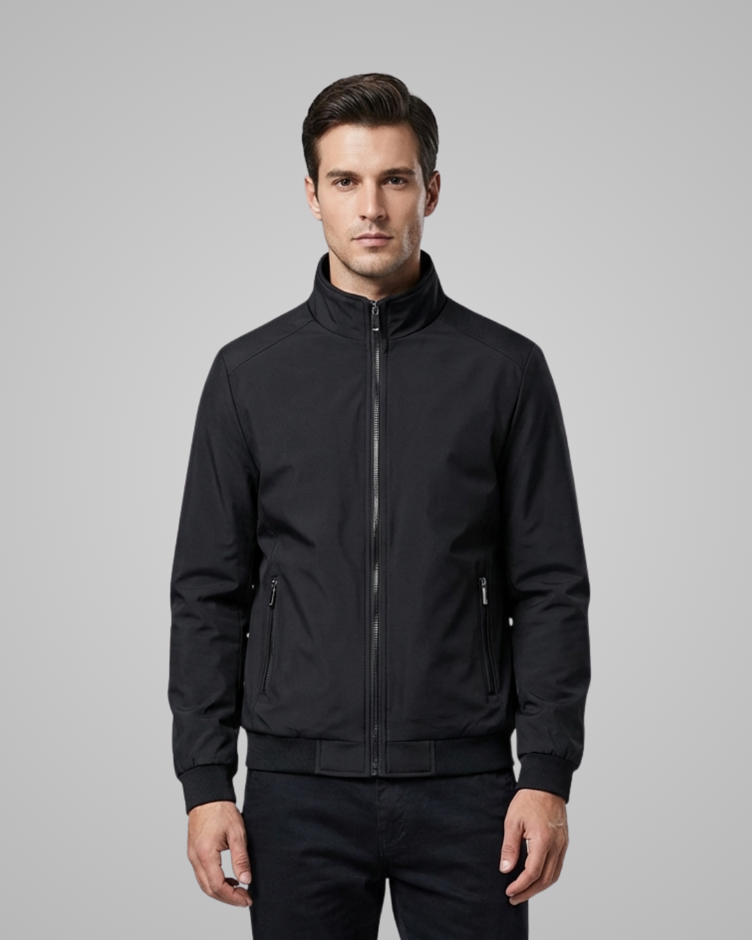 Man wearing a black jacket on a gray background