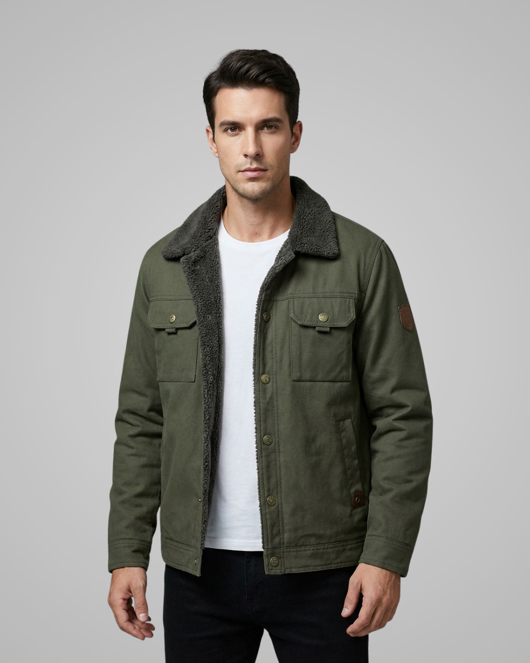 Man wearing a green jacket with a gray collar on a gray background