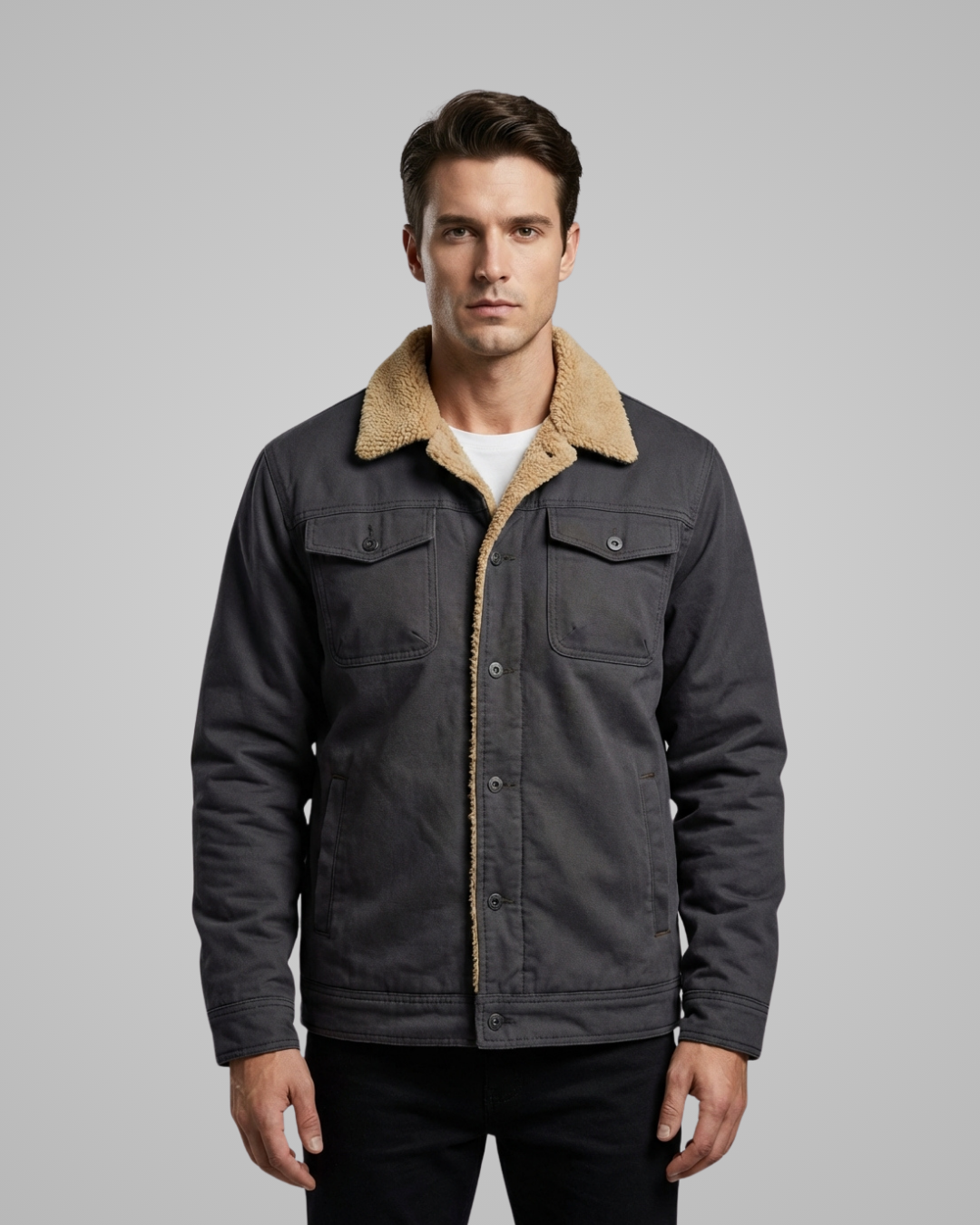 Man wearing a dark jacket with a beige collar against a gray background