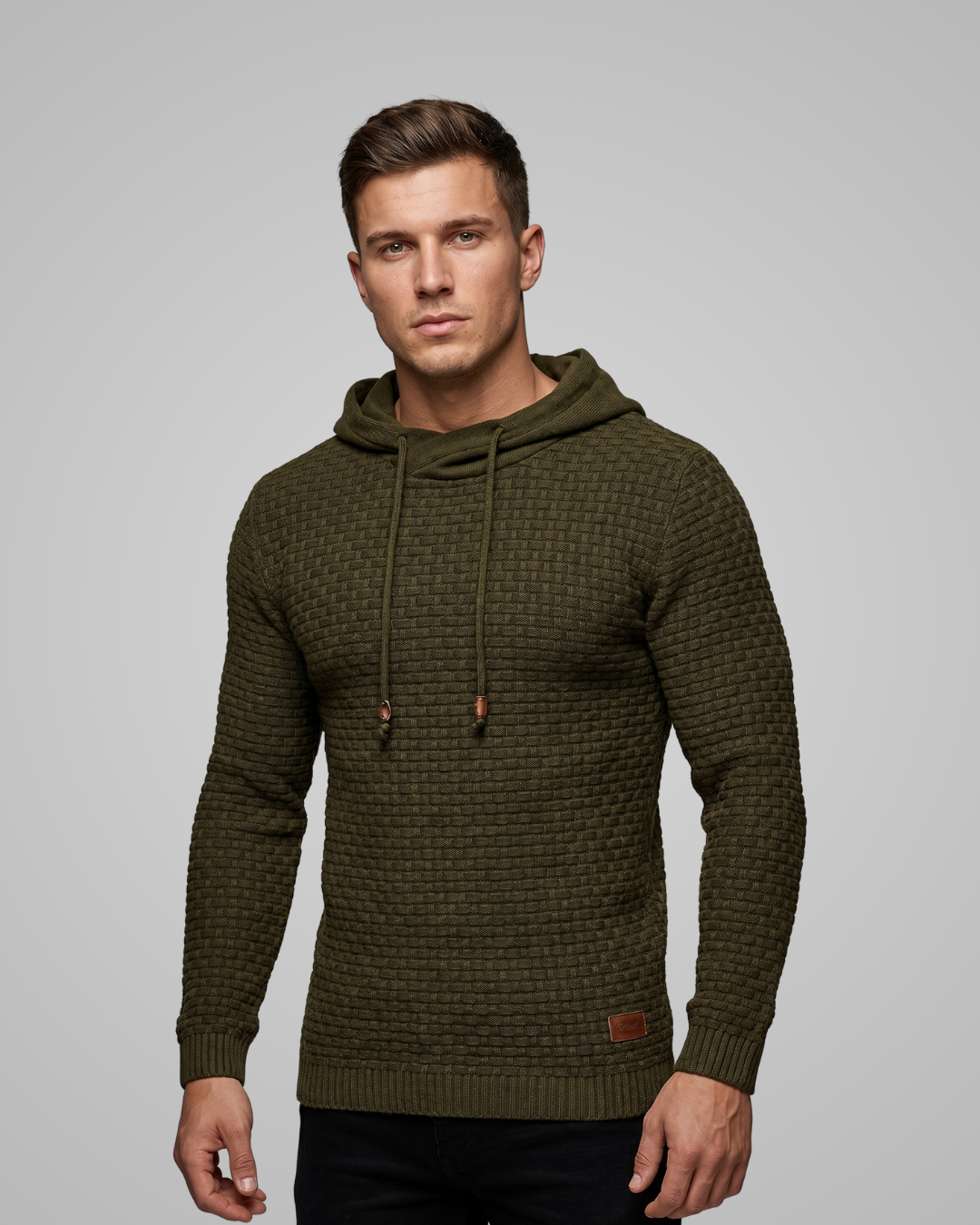 Man wearing a green textured hoodie on a gray background