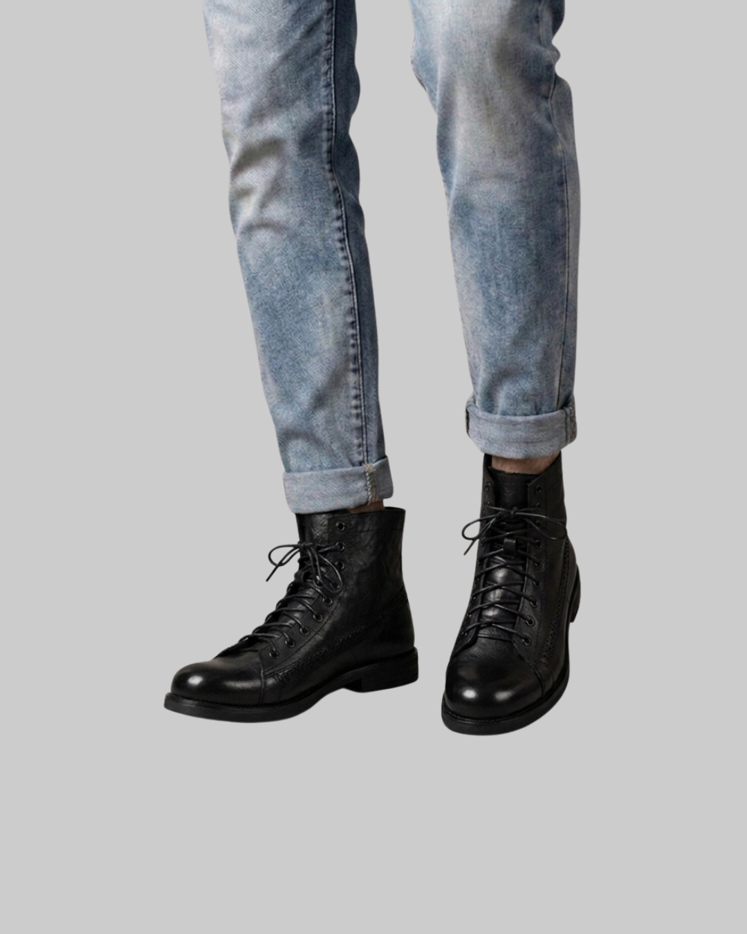 Worn Men's Braided Stitch Lace-Up Boots in black.